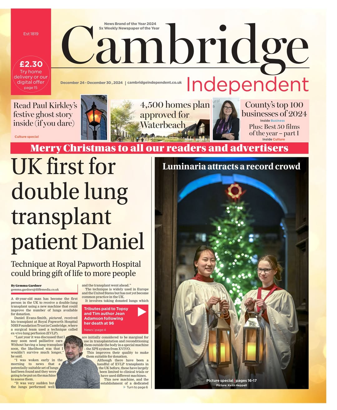 Newspaper cover from the Cambridge Independent with me (left) holding a large lantern before our Christmas Luminaria begins, 2024